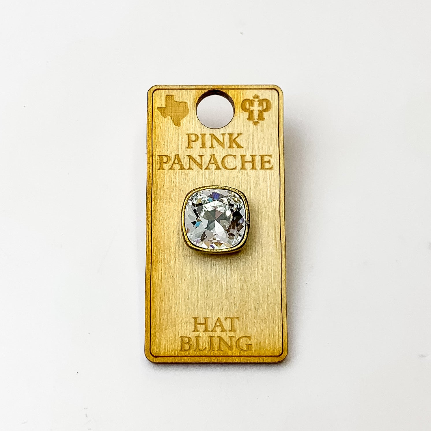 Bronze, square hat pin with a clear cushion cut crystal. This hat pin is pictured on a wooden Pink Panache holder on a white background.