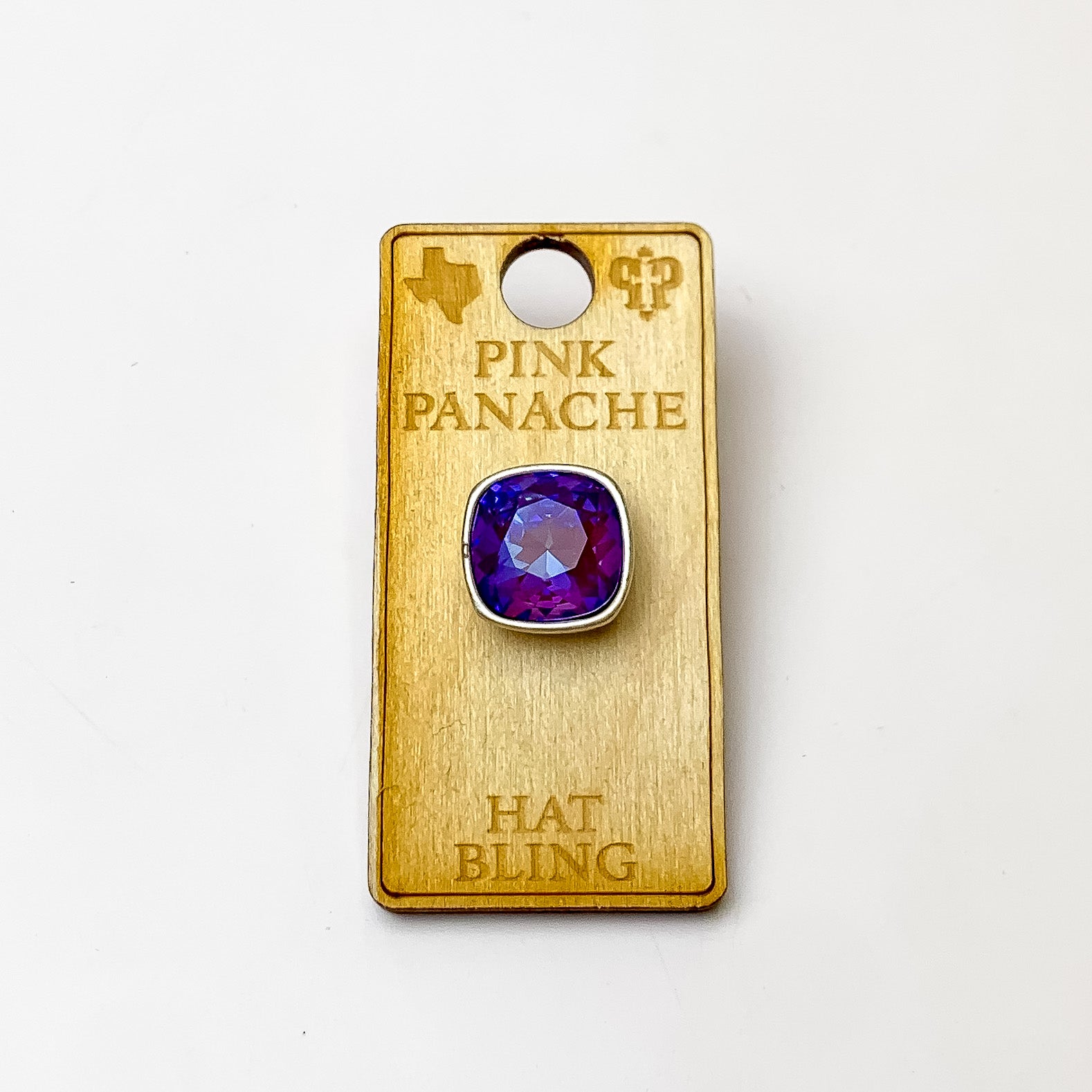 Silver, square hat pin with a burgundy delight cushion cut crystal. This hat pin is pictured on a wooden Pink Panache holder on a white background.