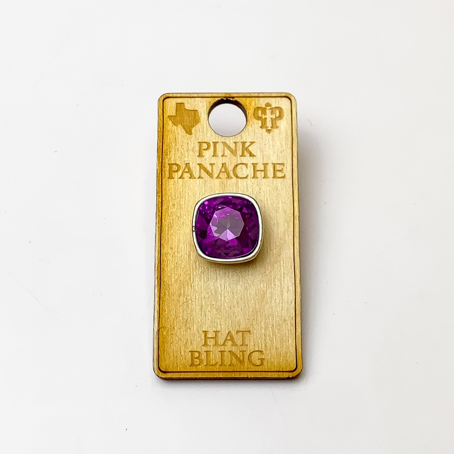 Silver, square hat pin with a amethyst cushion cut crystal. This hat pin is pictured on a wooden Pink Panache holder on a white background.