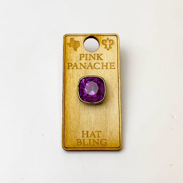 Bronze, square hat pin with a amethyst cushion cut crystal. This hat pin is pictured on a wooden Pink Panache holder on a white background.