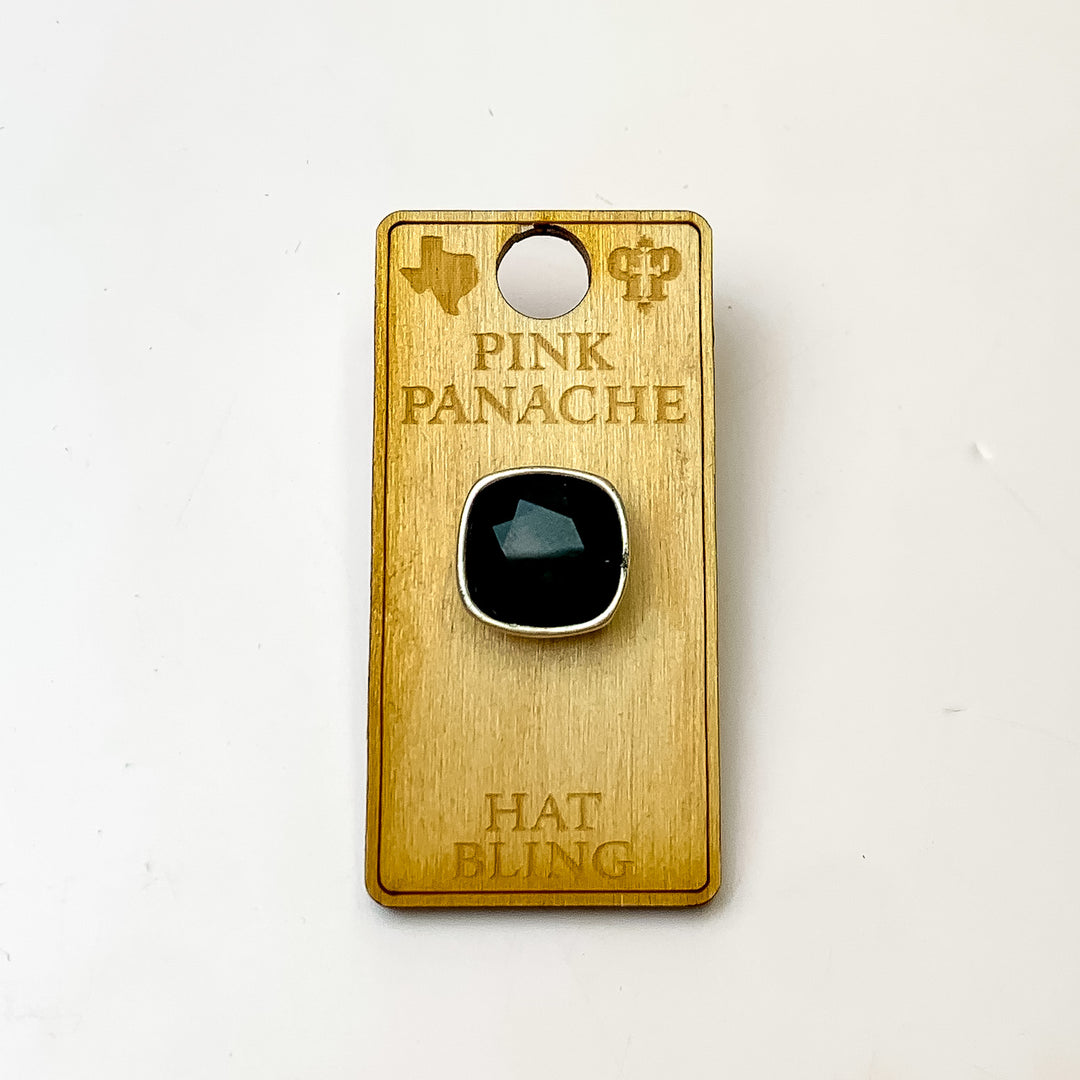 Silver, square hat pin with a black cushion cut crystal. This hat pin is pictured on a wooden Pink Panache holder on a white background.