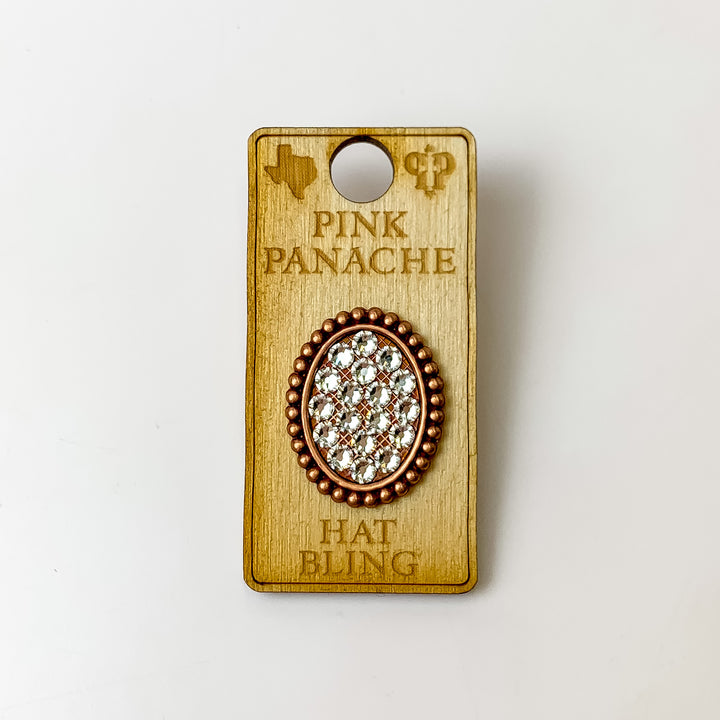 Rose gold, oval hat pin with a clear crystal inlay. This hat pin is pictured on a wooden Pink Panache holder on a white background.