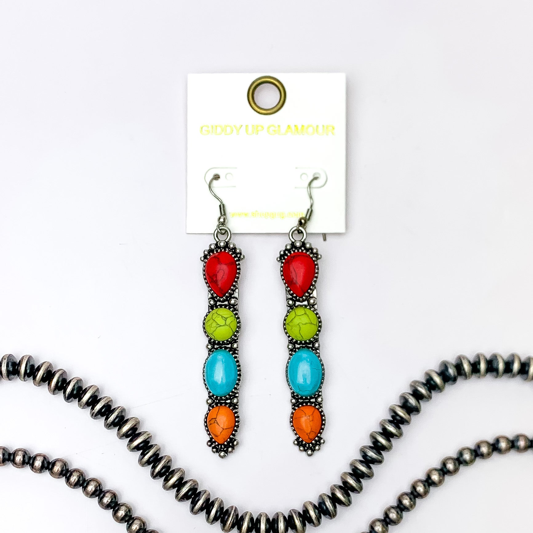 Silver fish hook earrings with a four, multicolor stone pendant. These earrings are pictured on a white background with silver beads at the bottom of the picture. 