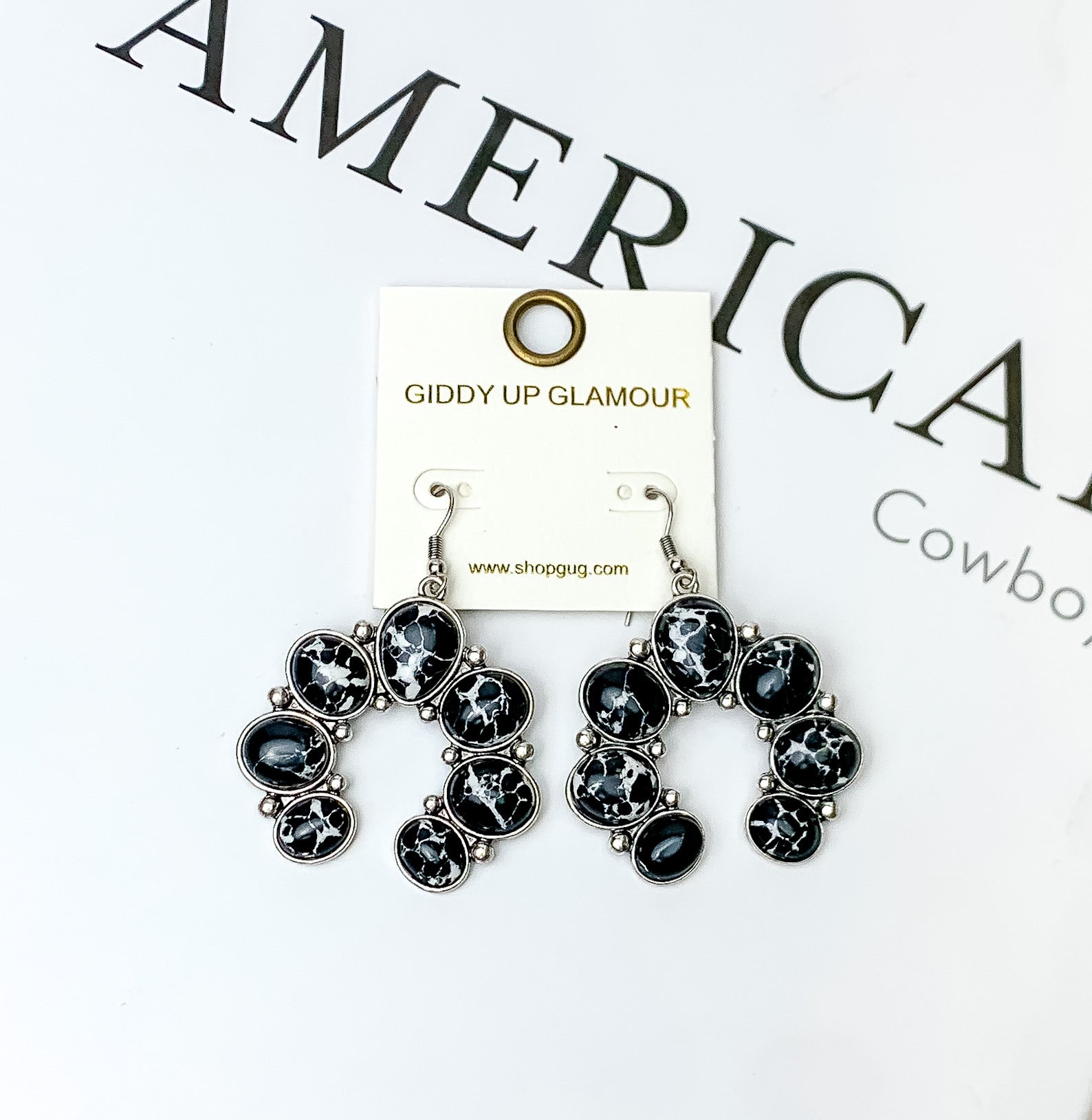 Squash Blossom Stone Earrings In Black. Pictured on a white background with American cowboy written in the background.