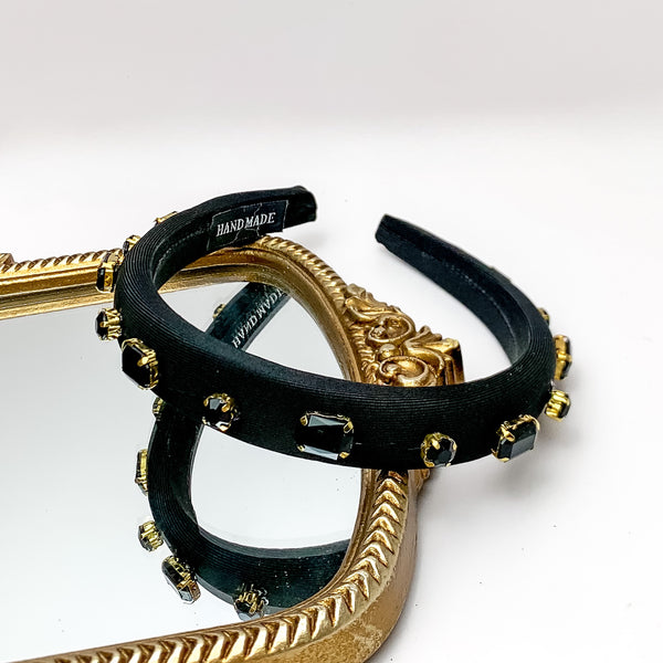 Crystal Detailed Headband in Black. Pictured on a white background with the headband laying on a gold trimmed mirror.
