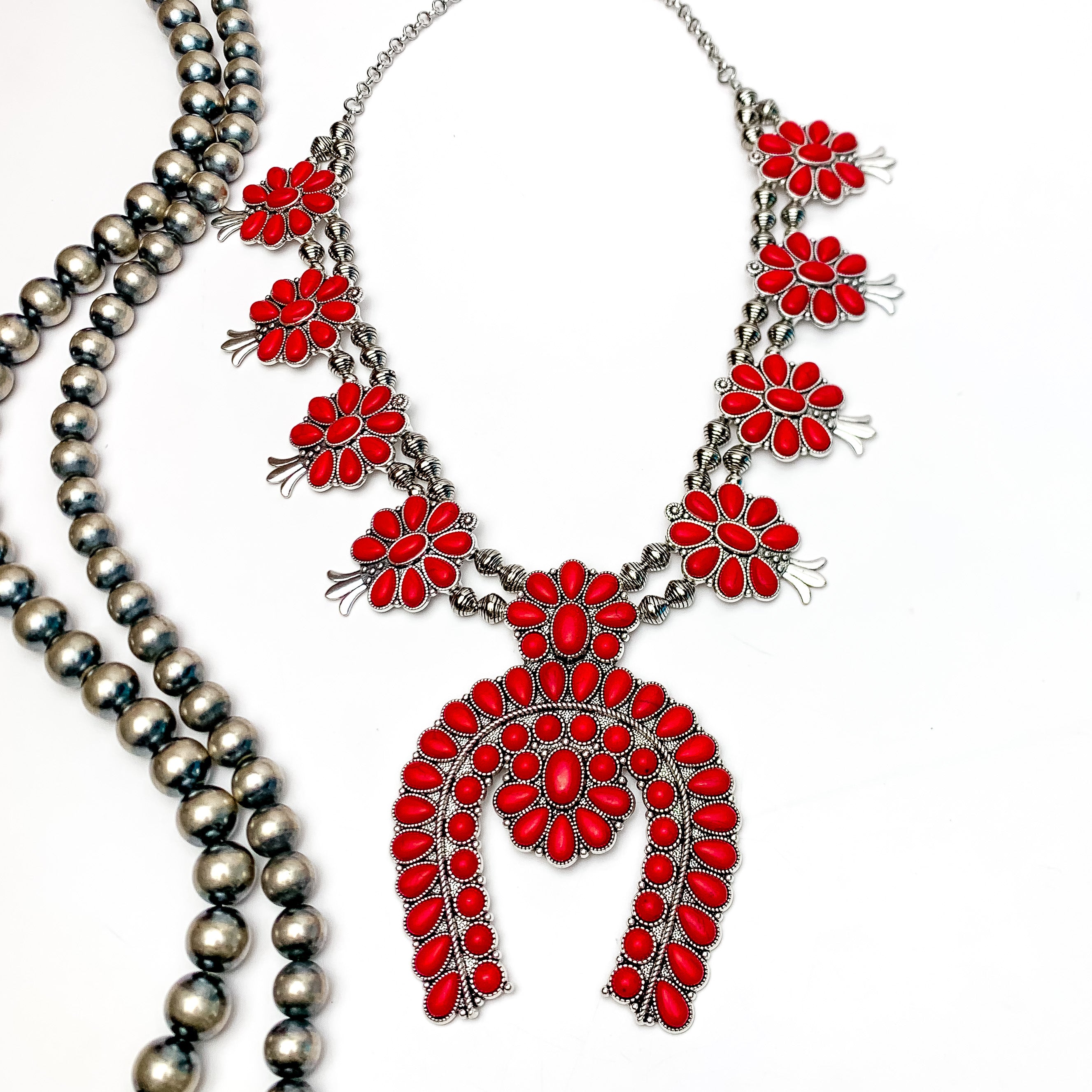 Western Women Squash Blossom Necklace in Red. Pictured on a white background with Navajo beads on the left side.