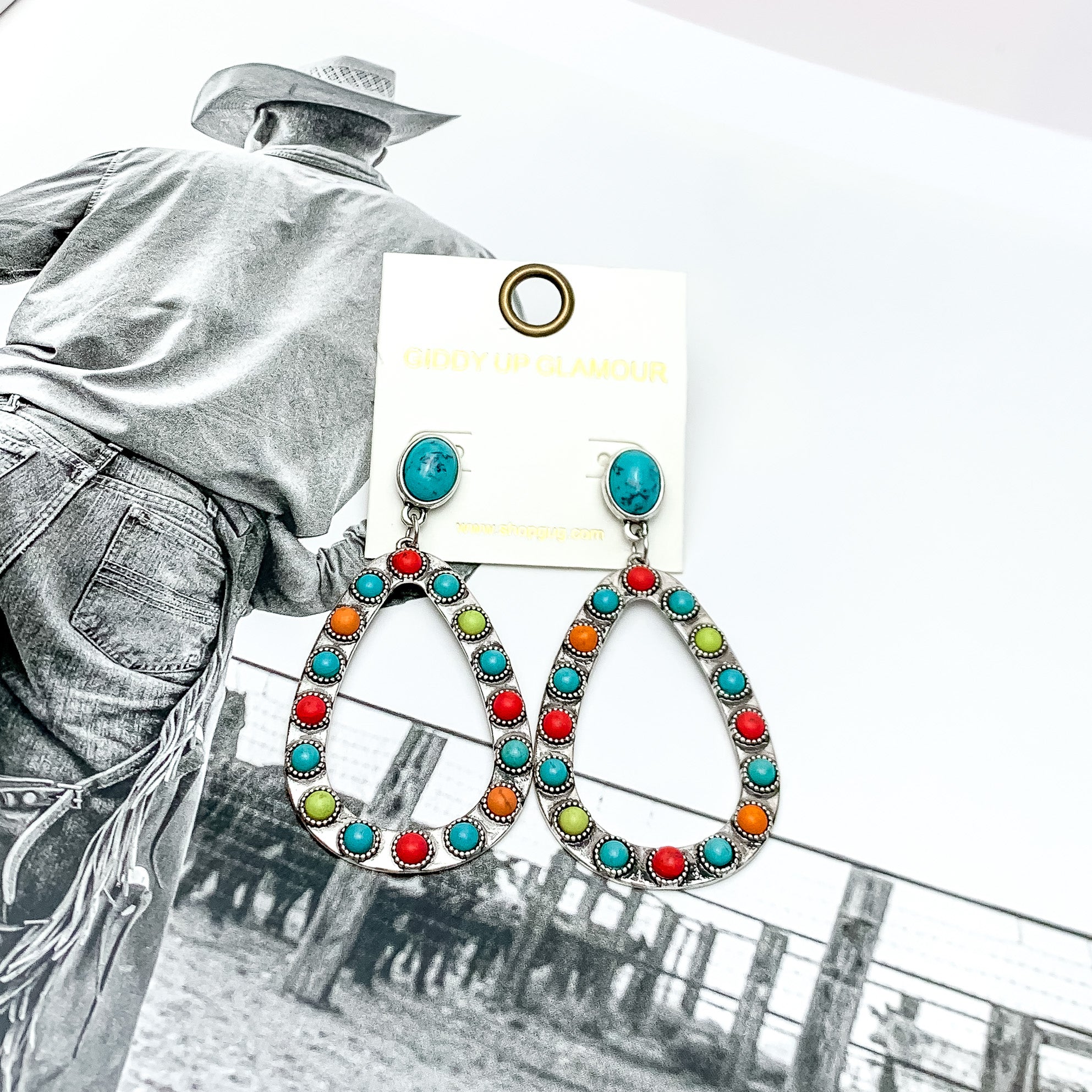 Western Open Teardrop Earrings With Stones in Multicolor. Pictured on a western background picture.