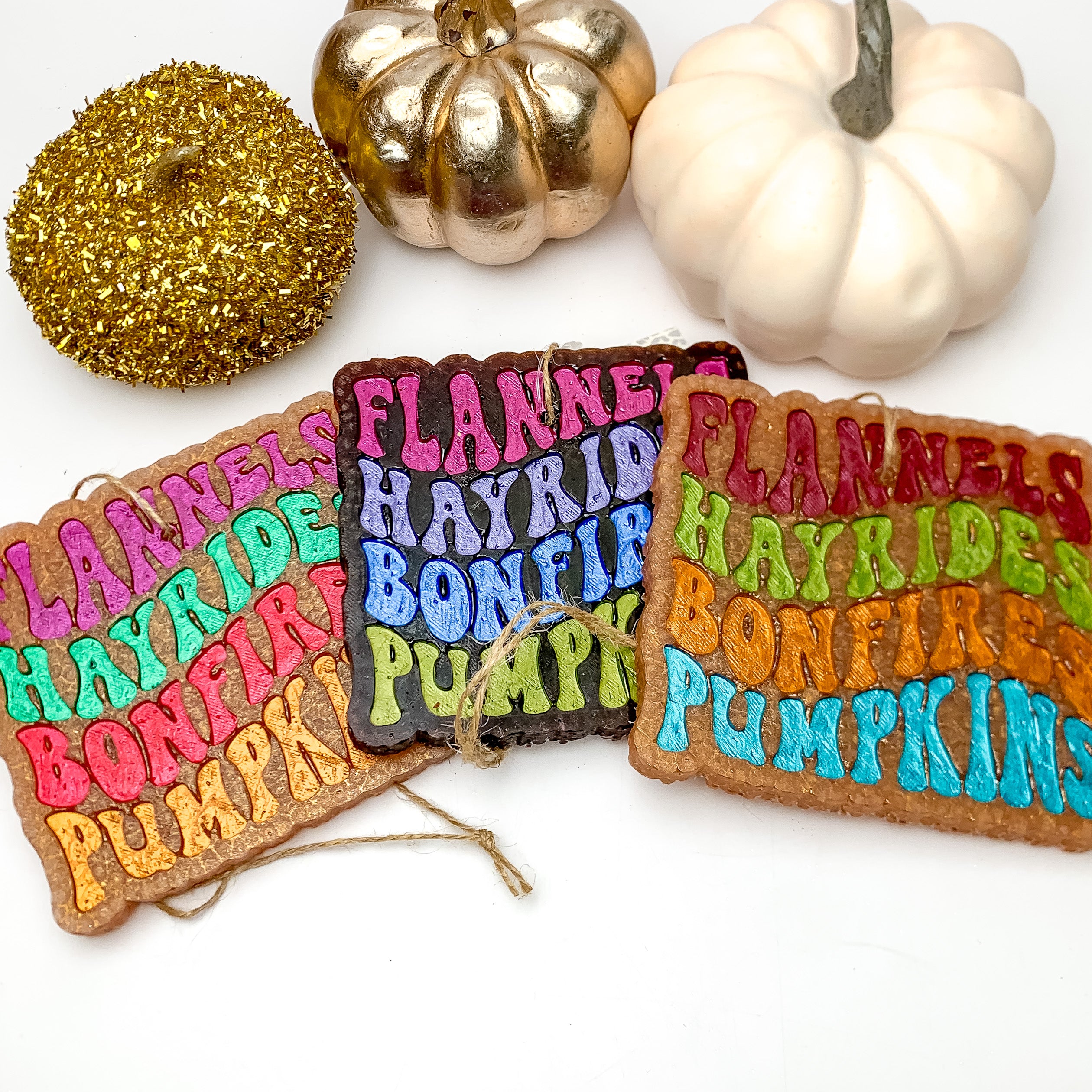 "Flannels Hayrides Bonfires Pumpkins" Freshie in Vanilla Pumpkin Marshmallow. These freshies are pictured on a white background with pumpkins above them.