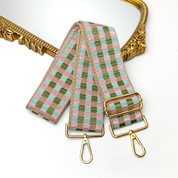Checkered Adjustable Purse Strap in Neutral Tones. This purse strap is pictured on a white background with a gold trimmed mirror in the corner.