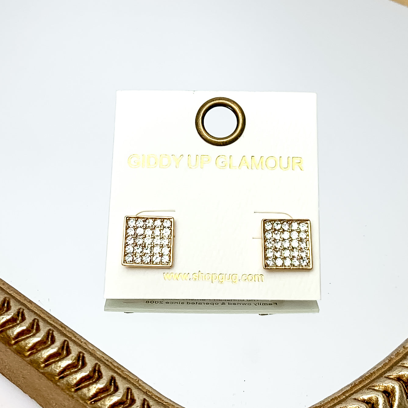 Square Clear Crystal Stud Earrings in Gold Tone. These earrings are pictured on a white background with a gold frame around.