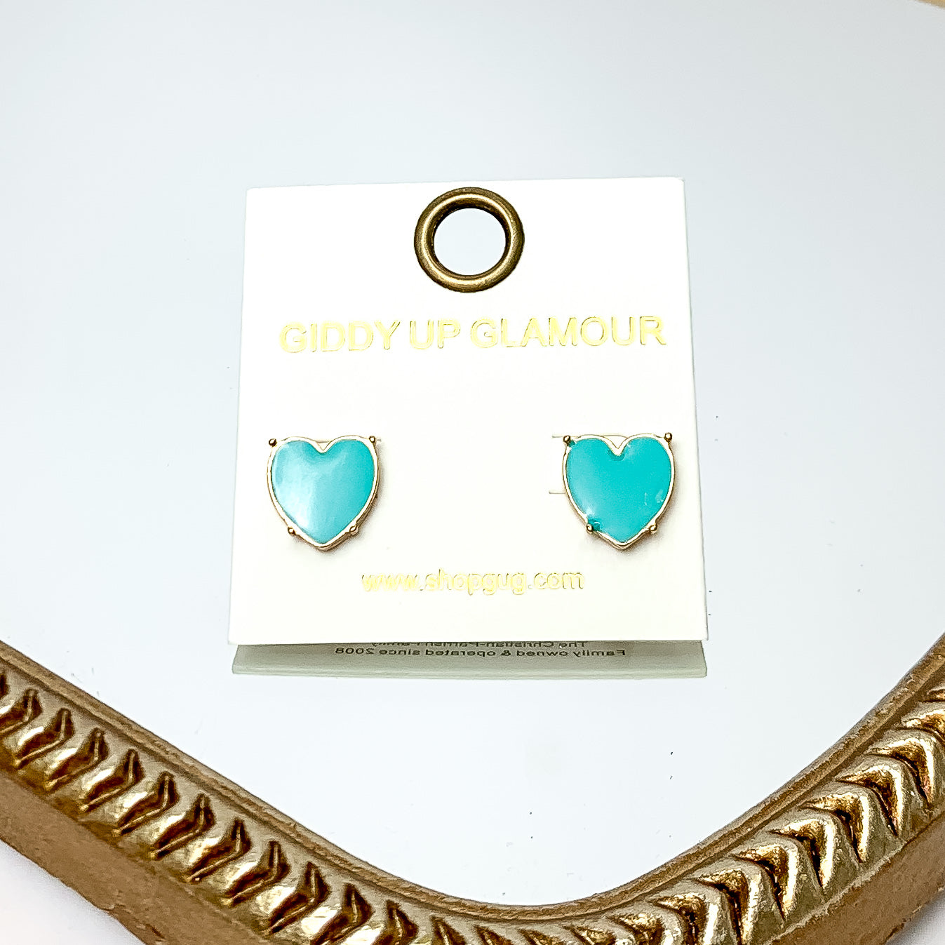 Gold Tone Heart Stud Earrings in Turquoise. These earrings are pictured on a white background with a gold frame around.