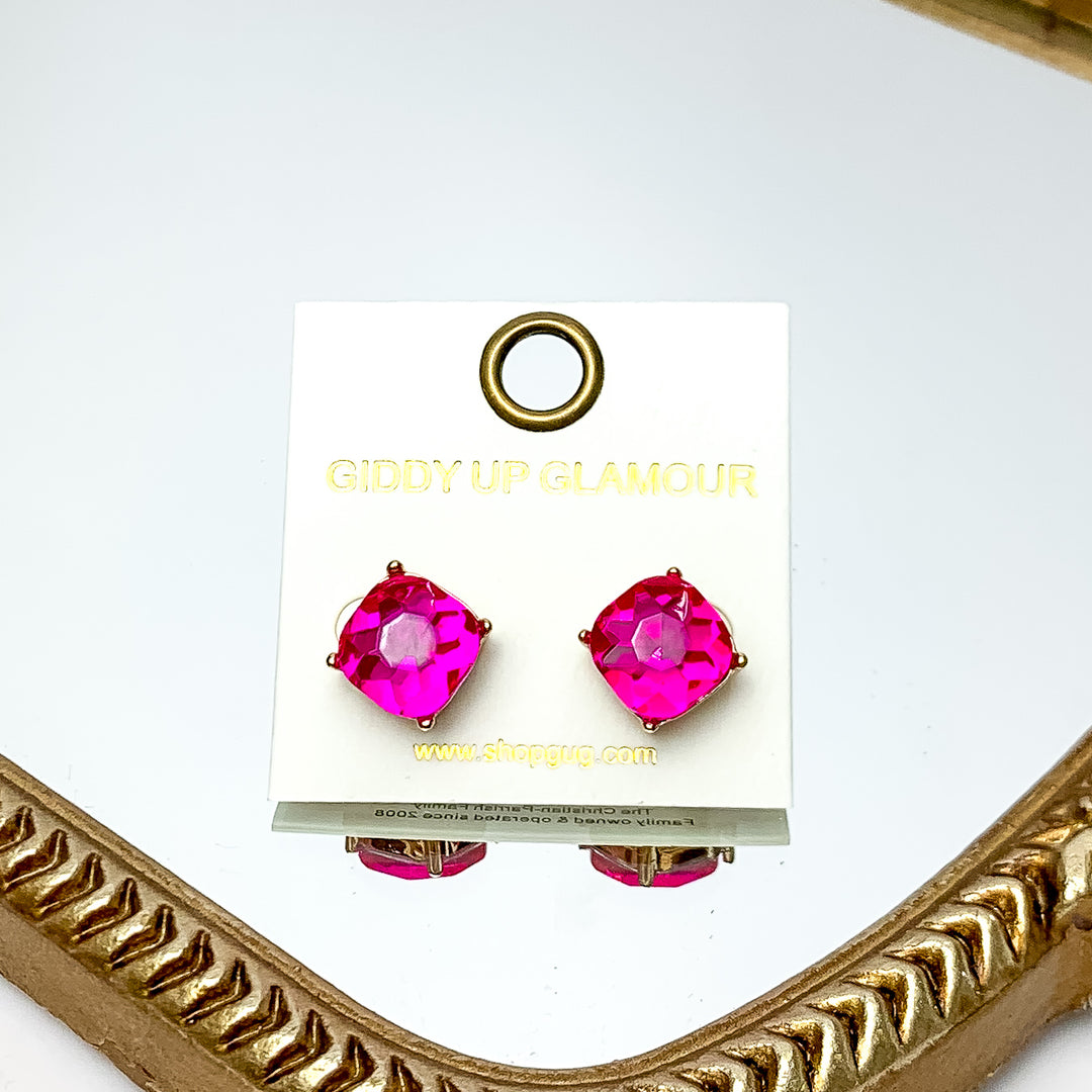 Large Crystal Stud Earrings in Hot Pink. These earrings are pictured laying on a gold trimmed mirror.