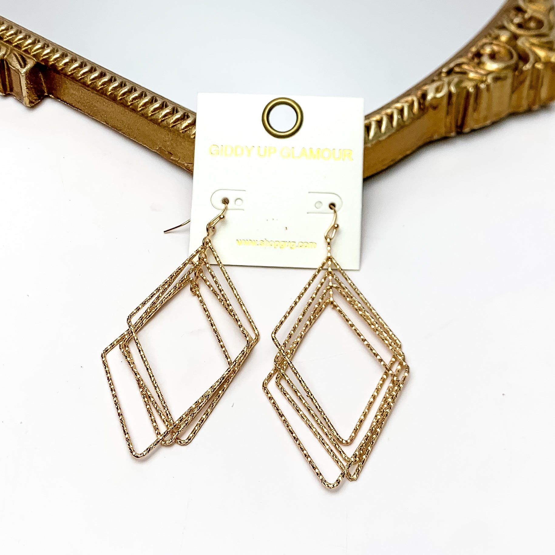 Multiple layered Diamond Shaped Earrings in Gold Tone. These earrings are pictured on a white background with a gold frame around.