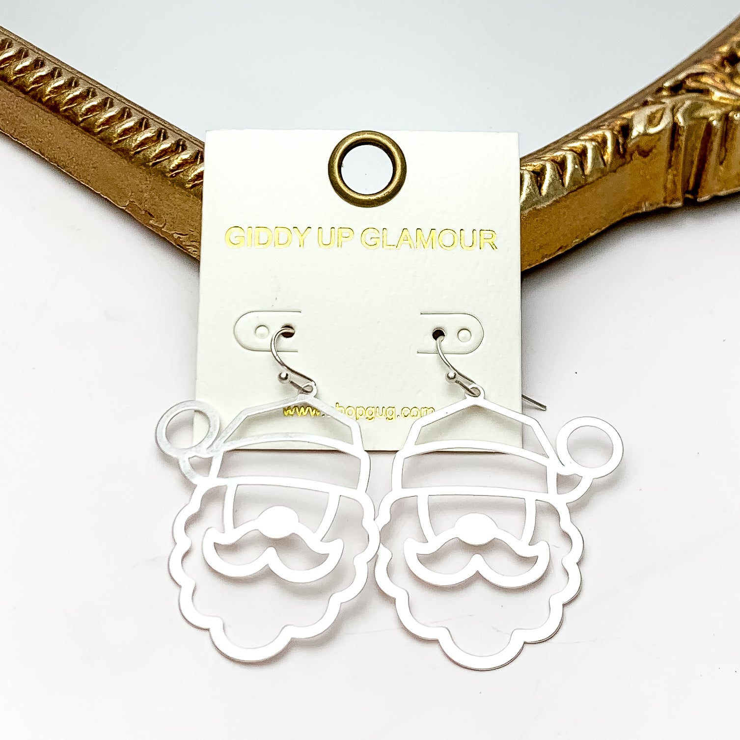 Santa Outline Earrings in Silver Tone. These earrings are pictured on a white background with a gold frame around.