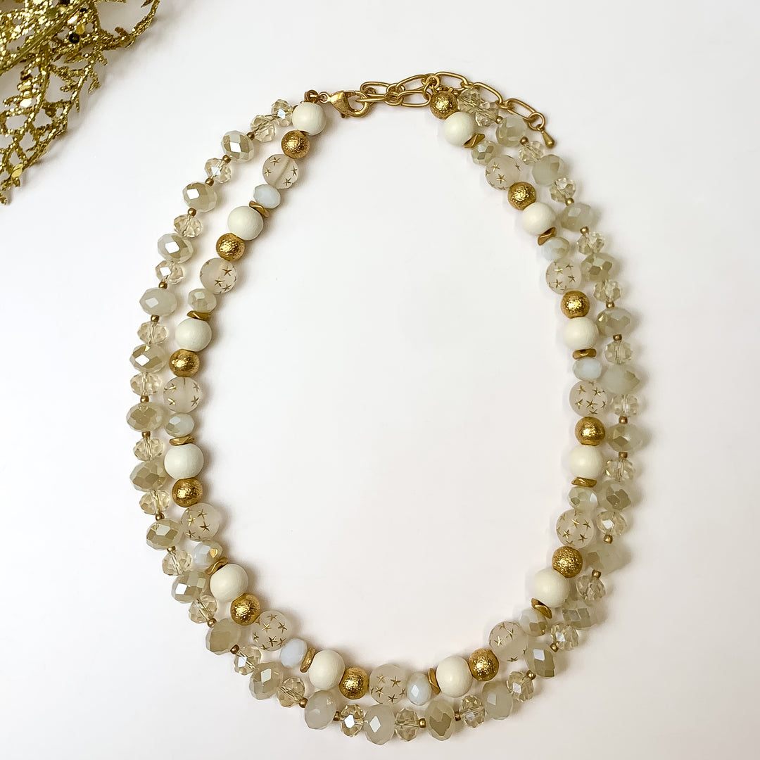 This NYC Dream Multi Strand White Necklace in pictured on a white background with old tinsel in the top left corner.