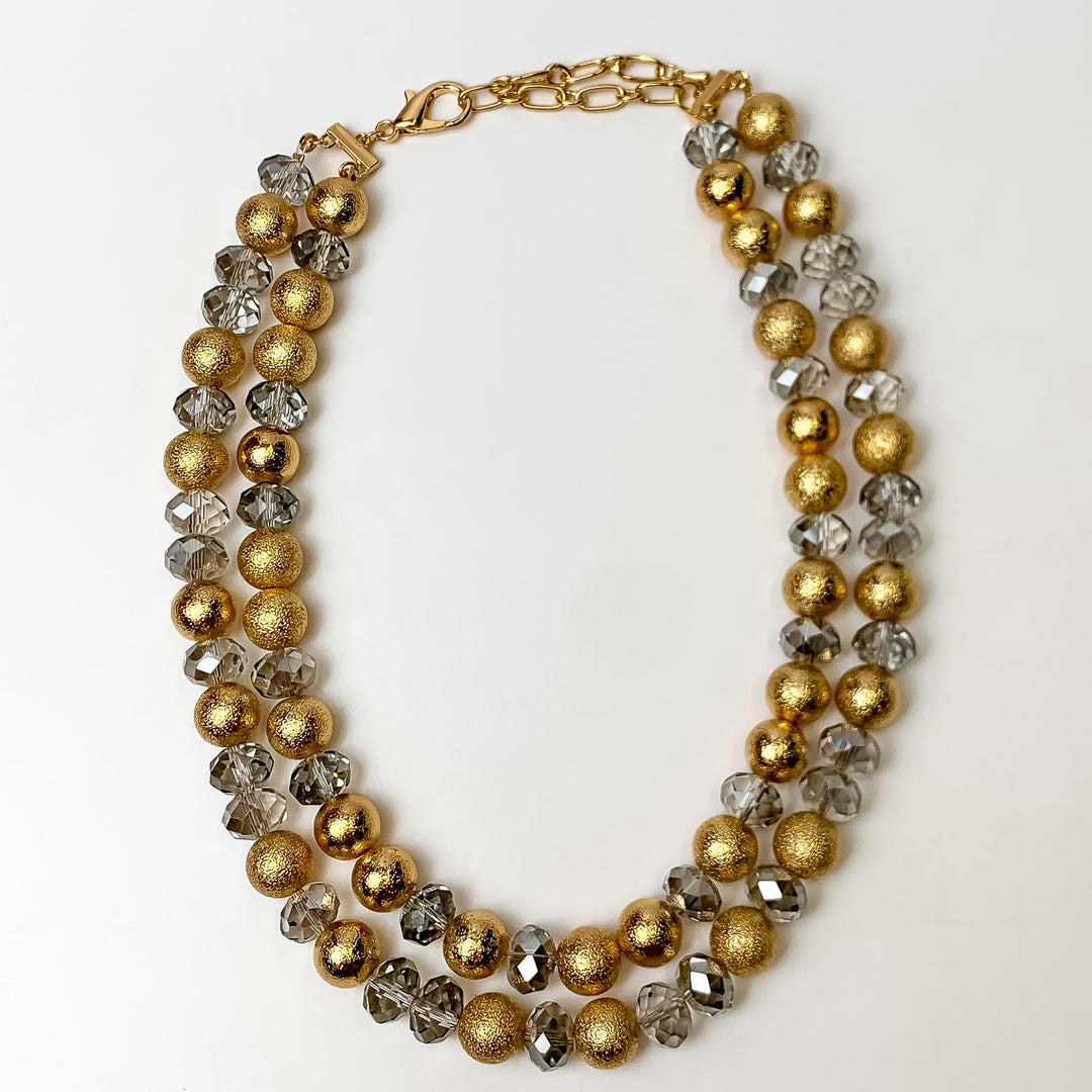 This Bold Statement Layered Necklace in Gold Tone and Clear is pictured on a white background.