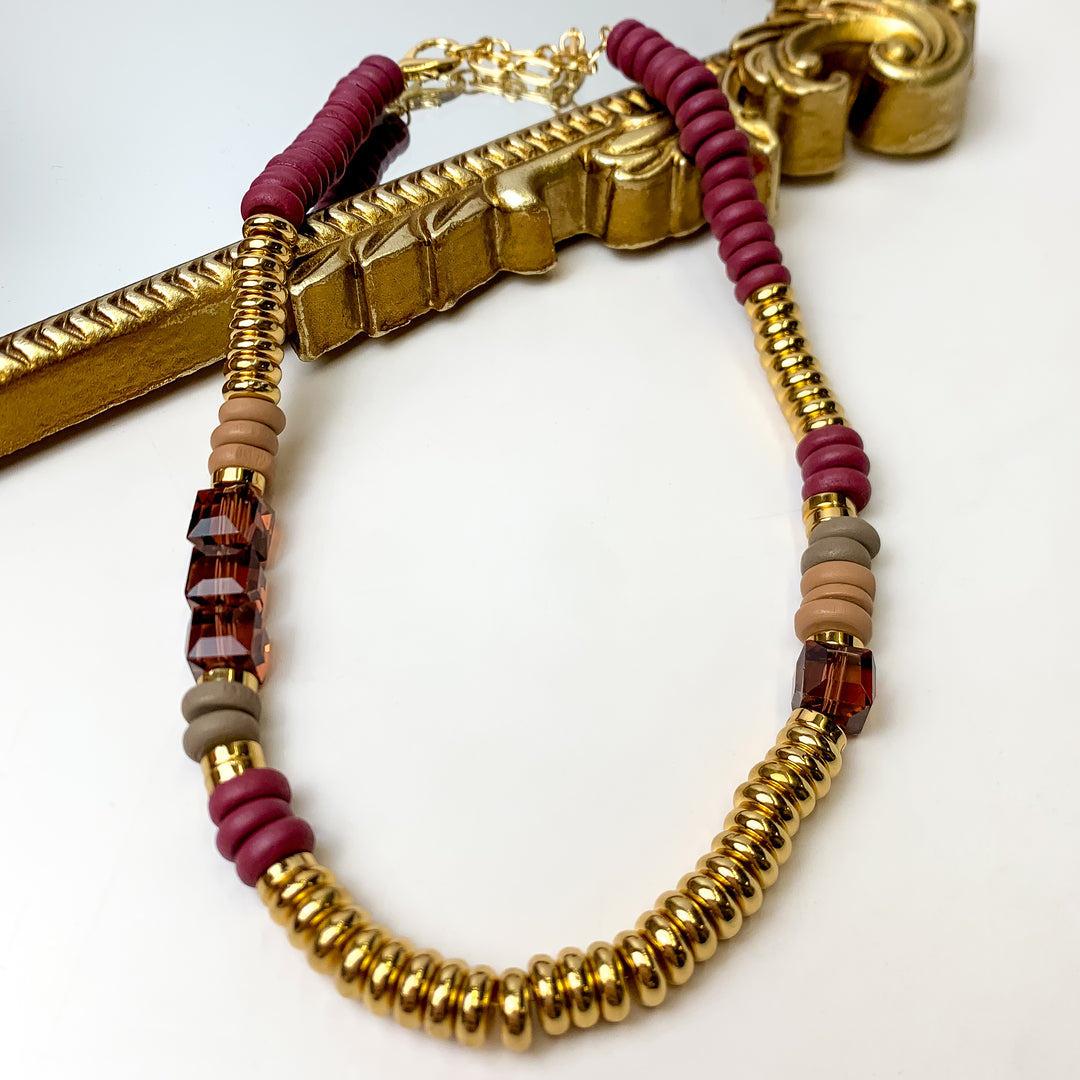 This Purple texture Beaded Necklace with Multicolored Spacers is pictured on a white background with a gold mirror.