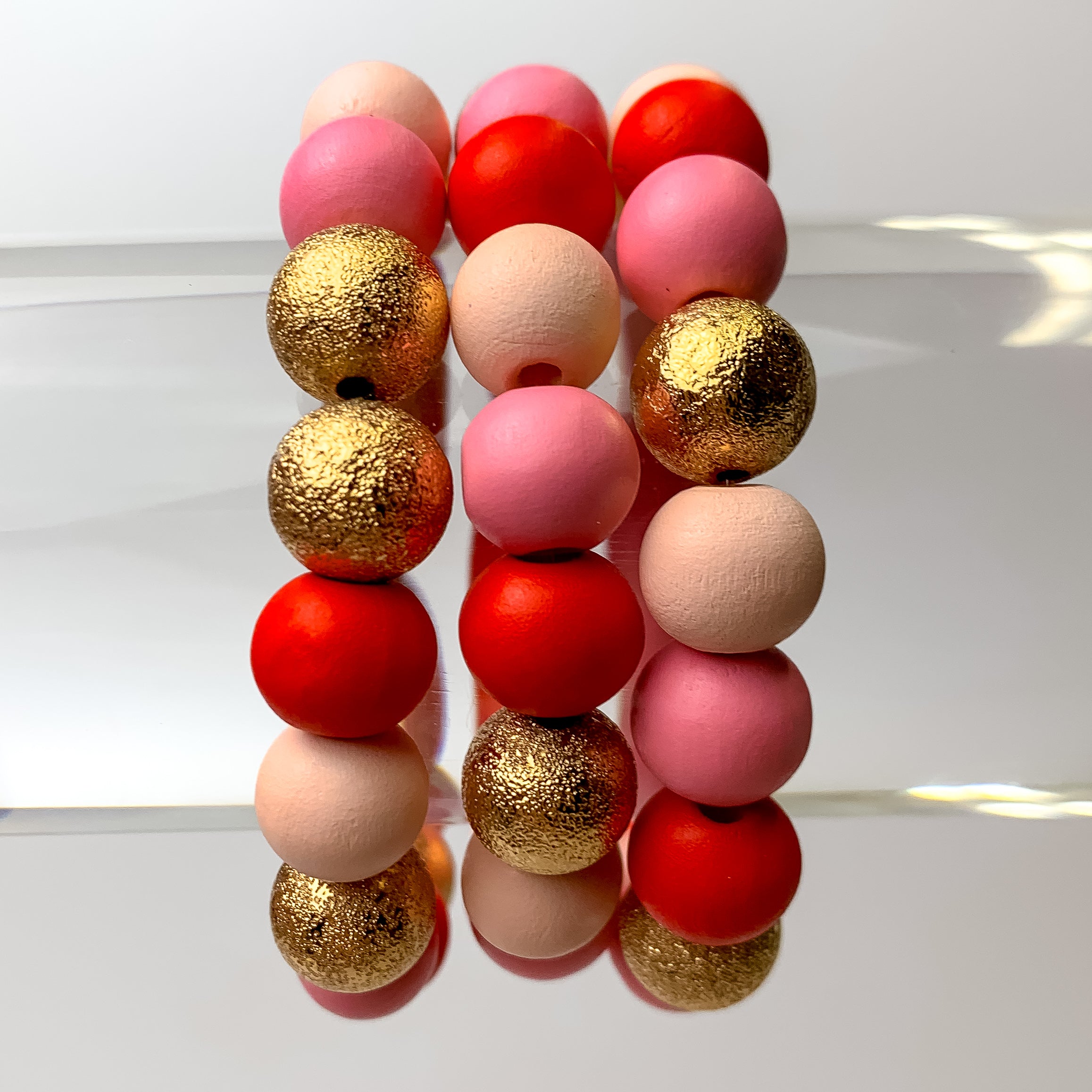 This Sweet Set of 3 Beaded Stretchy Bracelets are pictured on a bracelet display with a white background.