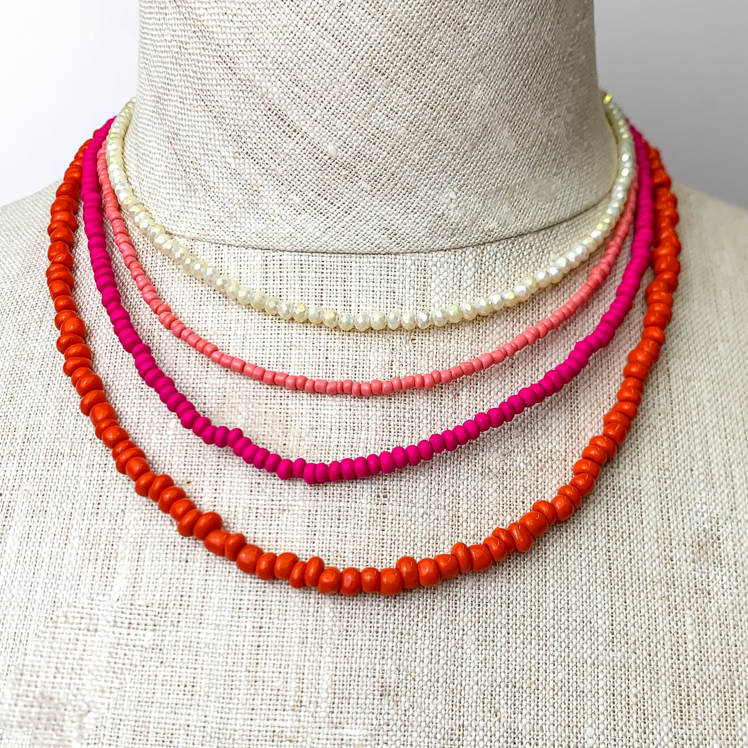 This Vibrant Multicolored Necklace Set is pictured on an ivory mannequin with a white background.