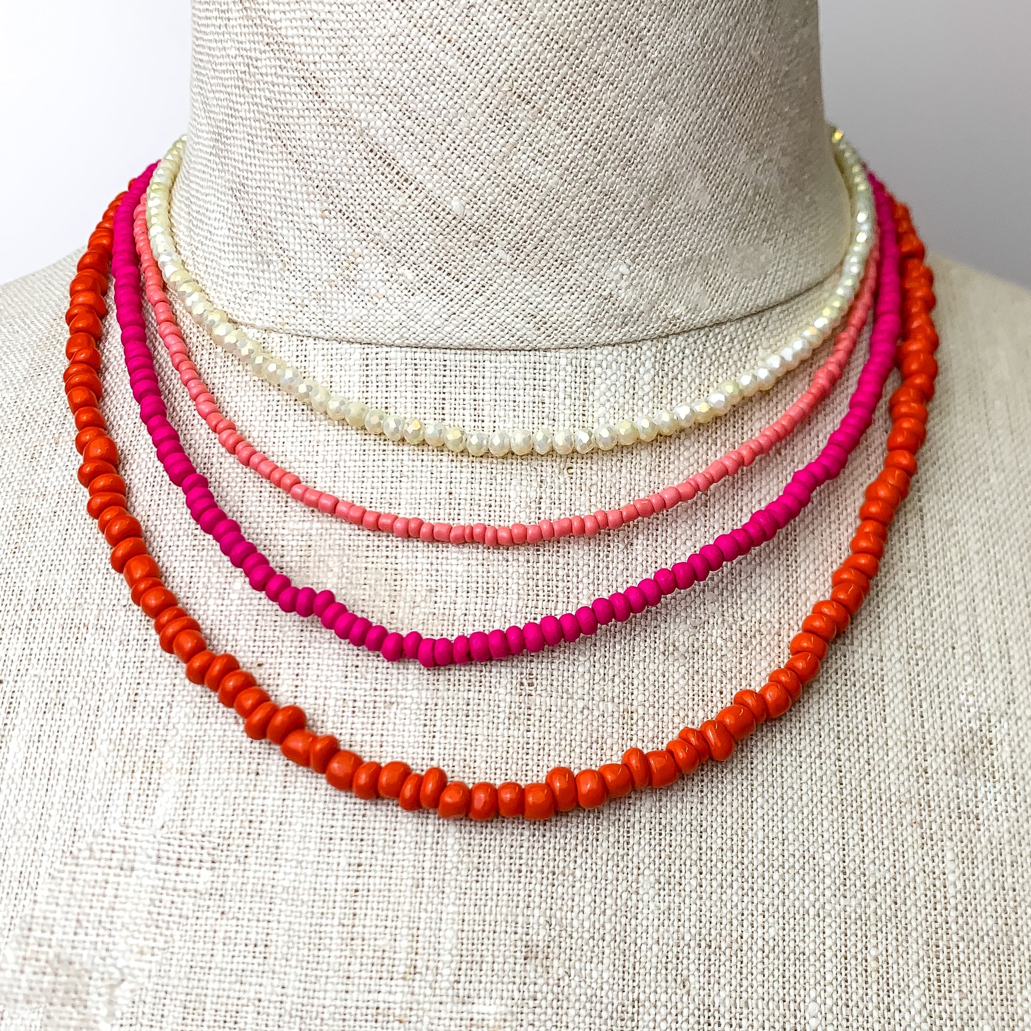 This Vibrant Multicolored Necklace Set is pictured on an ivory mannequin with a white background.