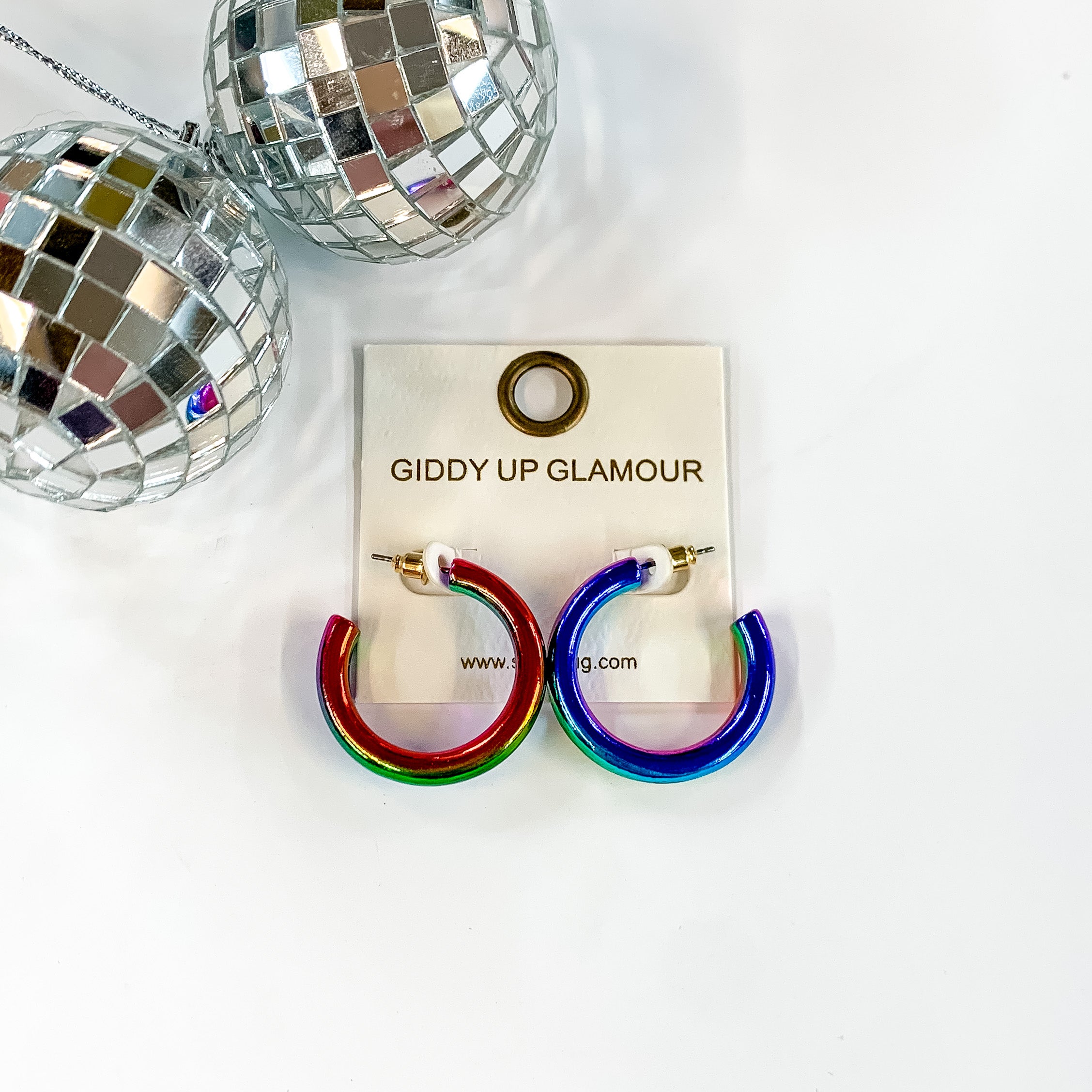 Light Up Small Neon Hoop Earrings In Multicolored. Pictured on a white background with a disco ball in the top left corner.