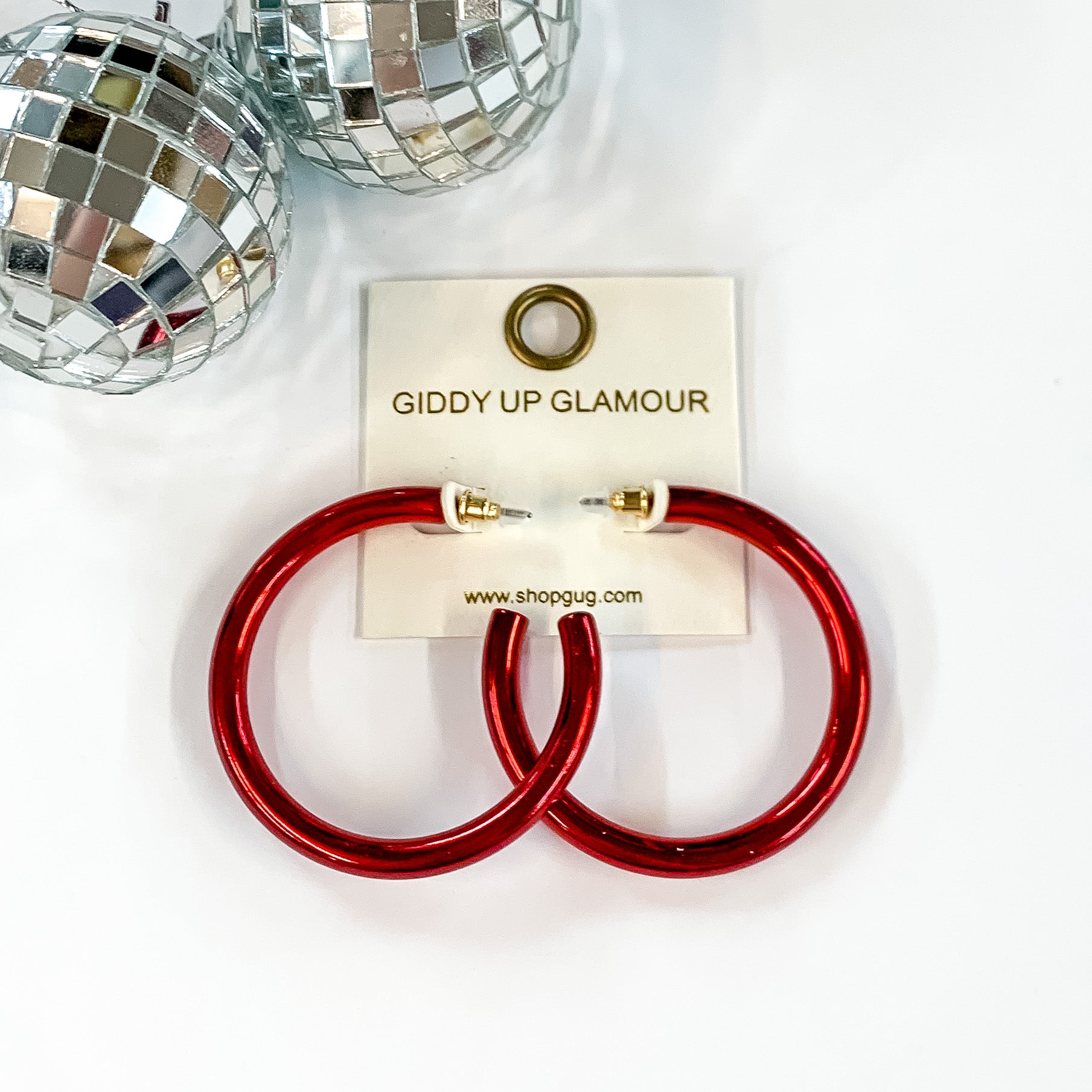 Light Up Large Neon Hoop Earrings In Red. Pictured on a white background with disco balls in the top left corner. 