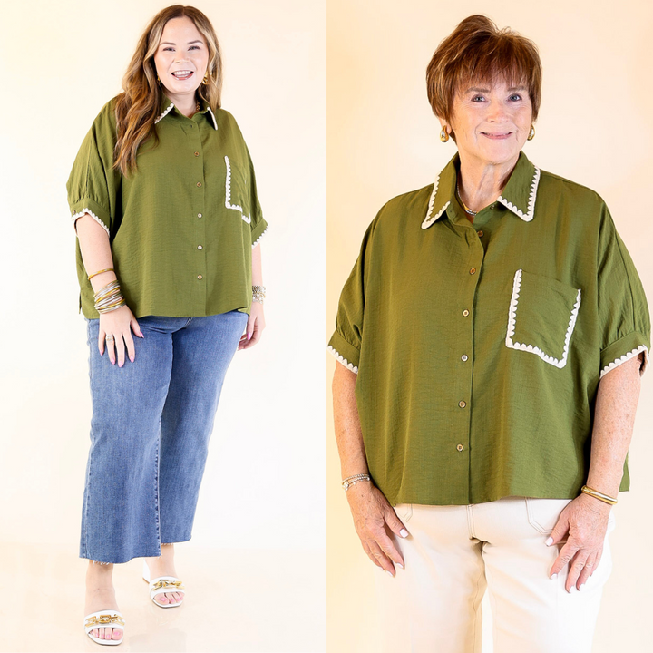 Two women wearing olive green button-up shirts with white trim against a beige background.