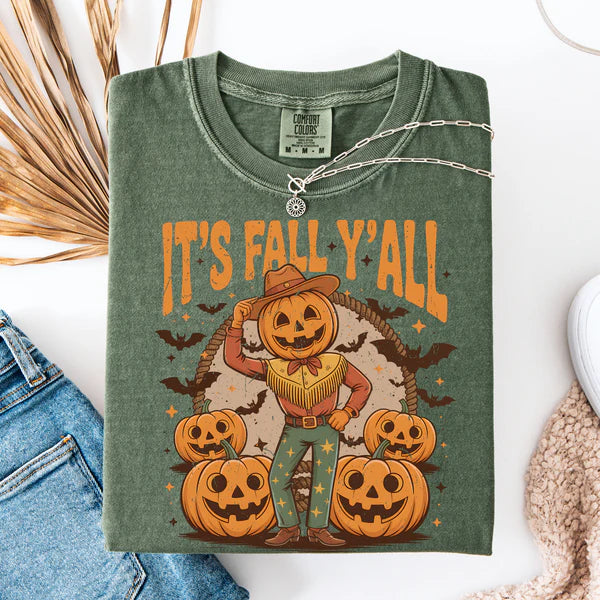 Green t-shirt with a cowboy pumpkin design and 'It's Fall Y'all' text, displayed with jeans and a necklace.