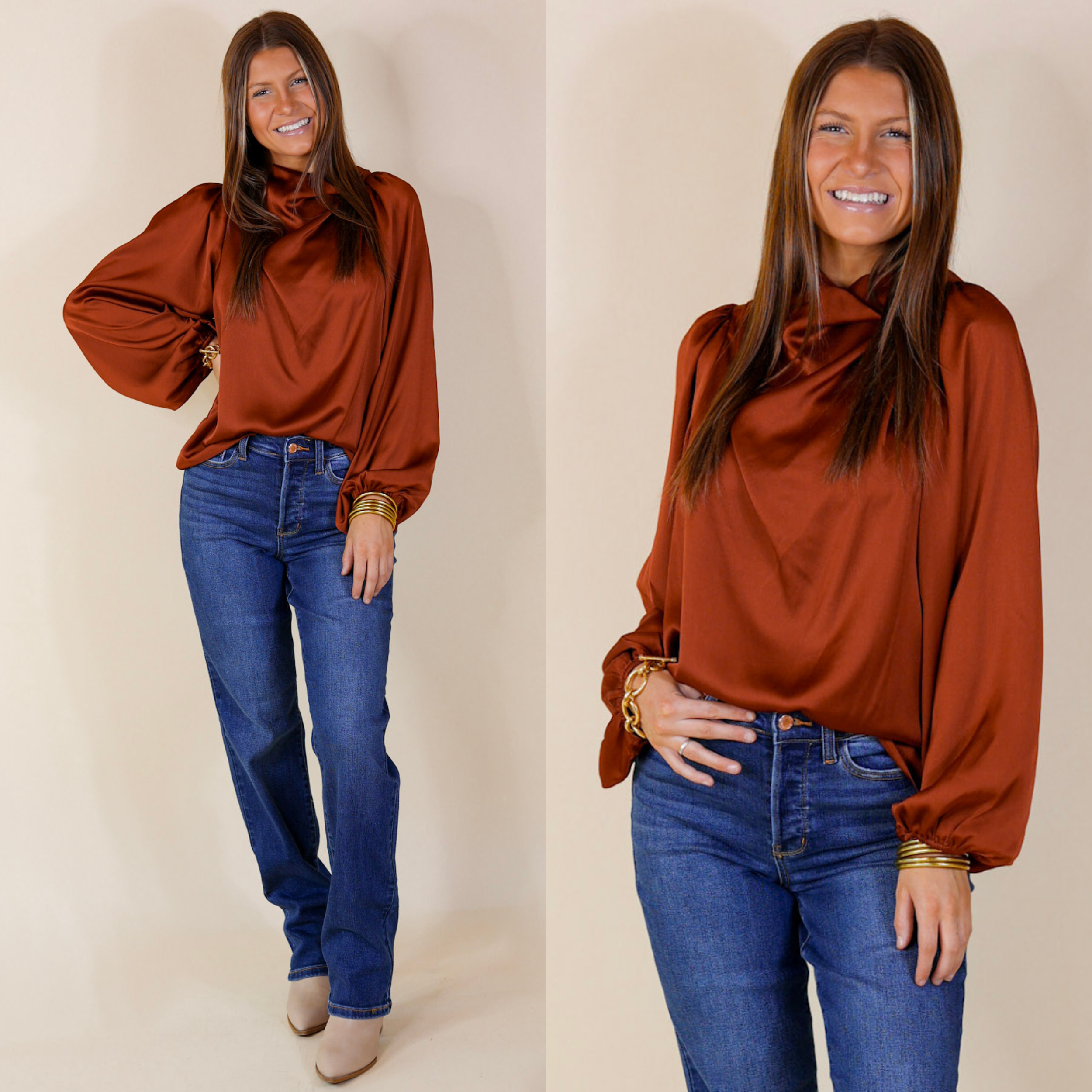 Model is wearing a rust orange long sleeve top with a cowl neckline. Model has this flowy top paired with denim jeans, ivory booties, and gold jewelry.