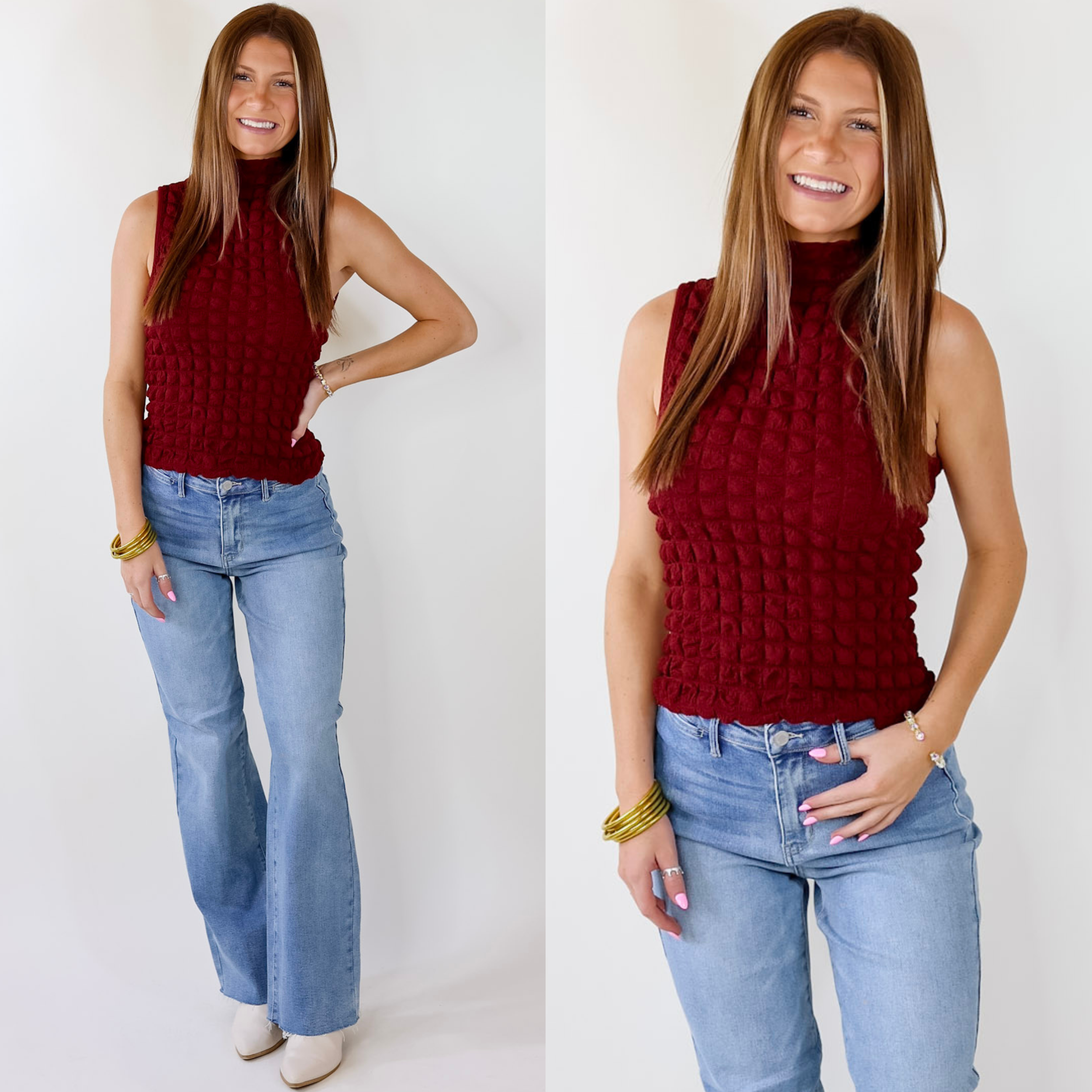 Model is wearing a maroon mock neck tank top. Model has this top paired with light wash jeans, white booties, and gold jewelry.