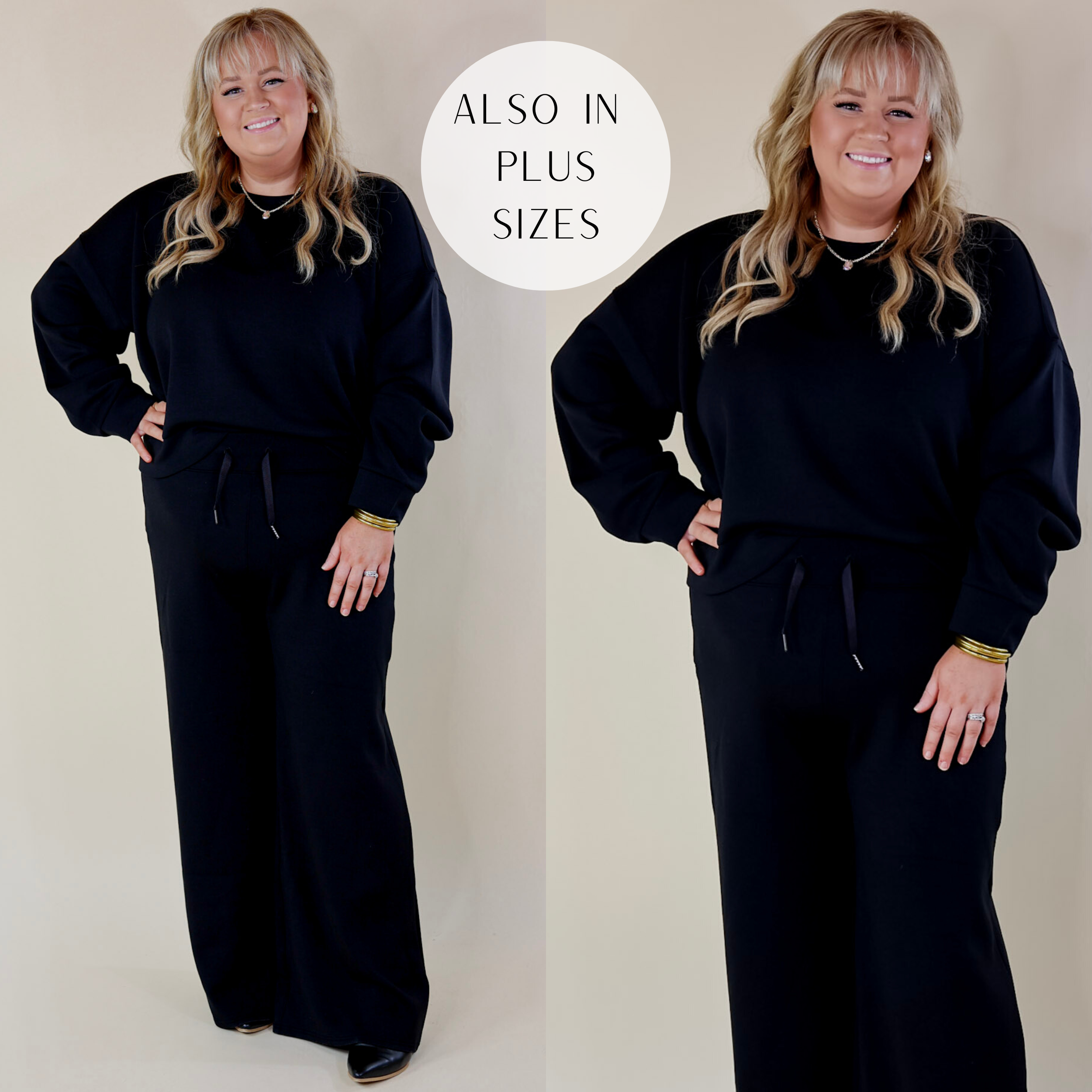 In the picture the model is wearing spanx airessentials crew neck pullover sweatshirt in black and has pairs it with black wide leg pants and black boots with a white background