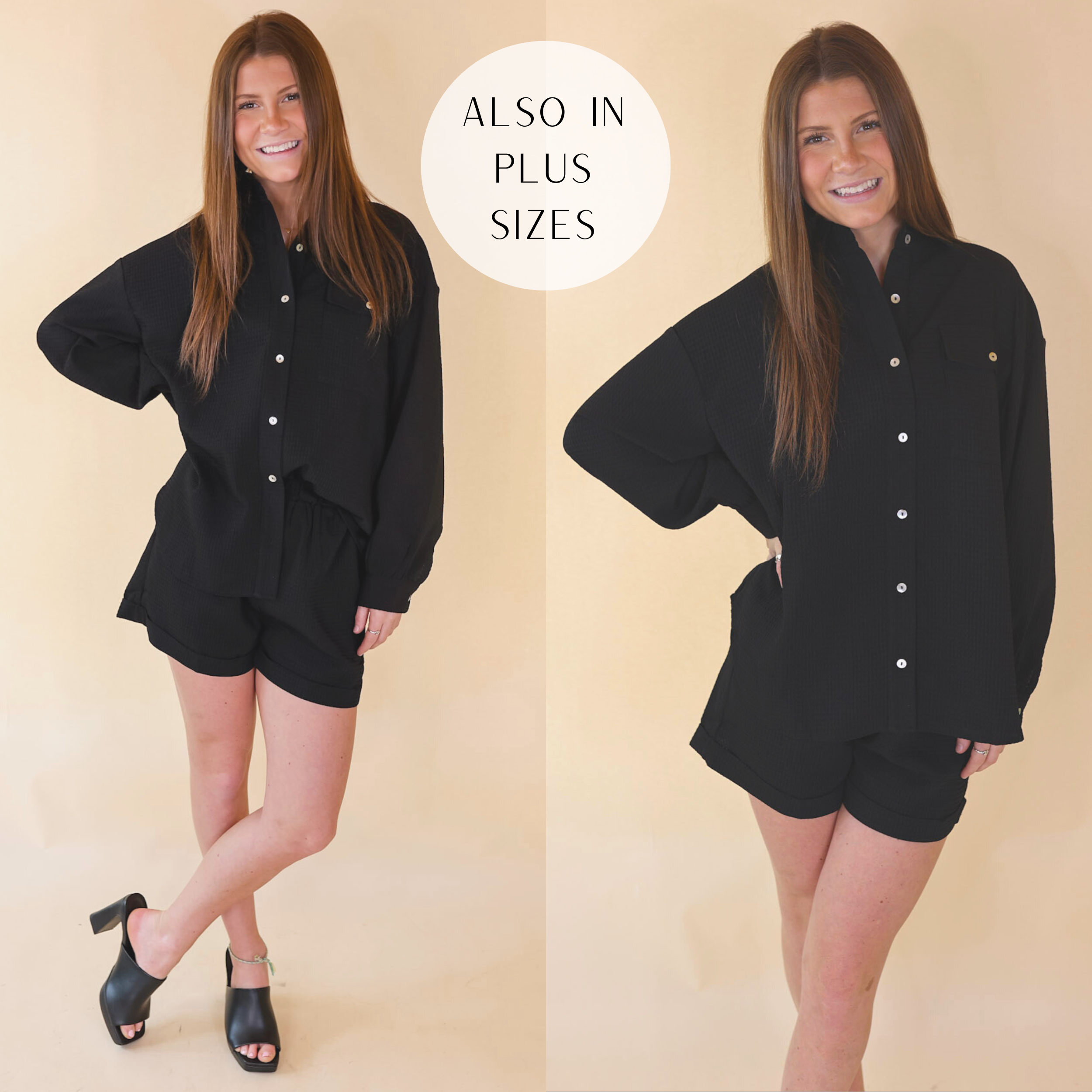 Model is wearing a button up waffle top with long sleeves in black. Model has it paired with matching black shorts, black heels, and gold jewelry.