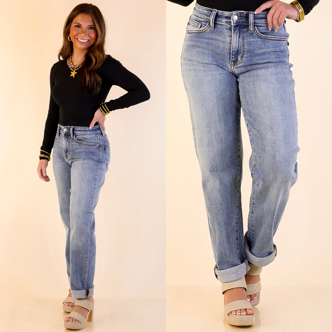 Woman wearing Boyfriend Denim Jeans in Medium Wash with a plain background