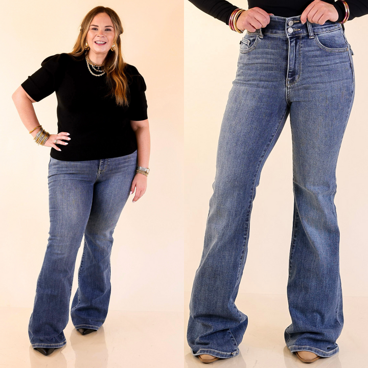 Two people wearing flare blue jeans on a beige background