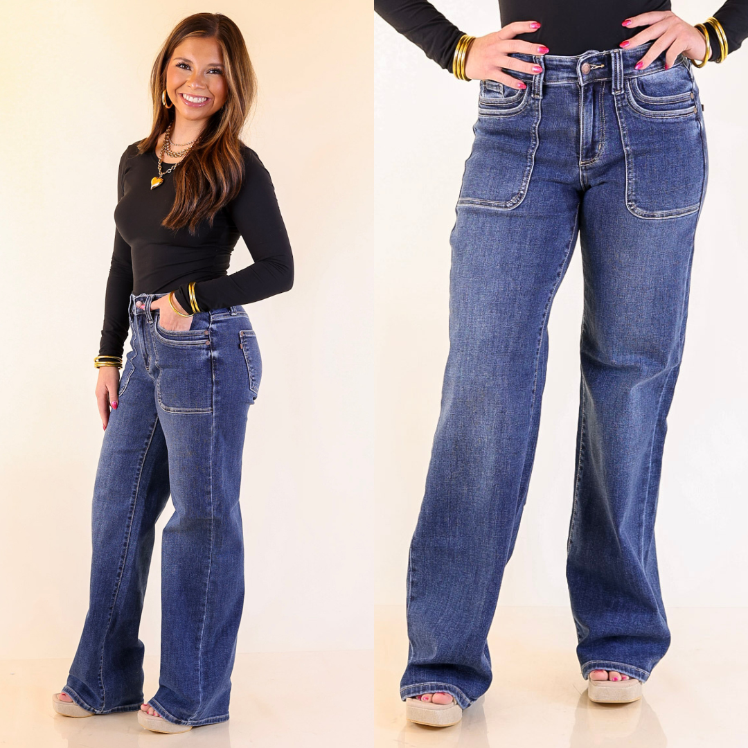 Woman wearing straight leg blue jeans with a plain background