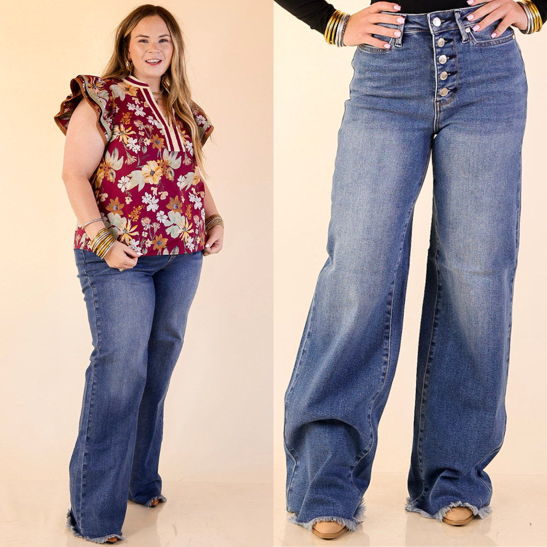 Women wearing straight wide leg button fly jeans and raw hem in dark wash.