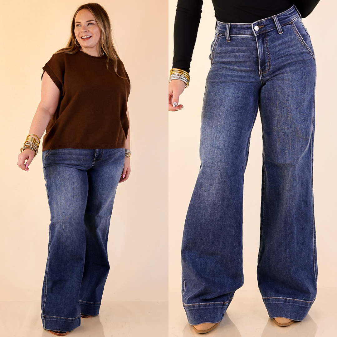 Model is wearing Retro Wide Leg Trouser Jean in Dark Wash on a beige background