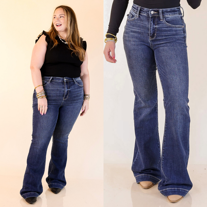 Woman wearing blue flared jeans with a close-up of the jeans on a plain background.