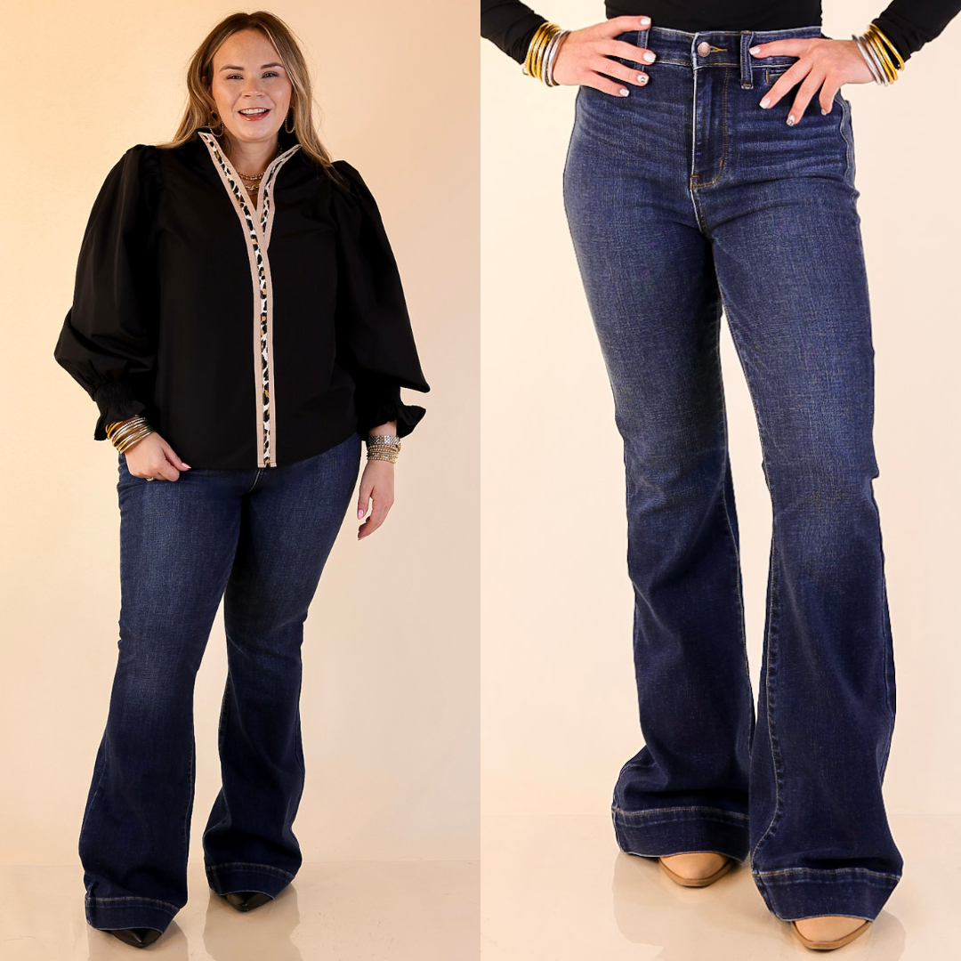 Model is wearing Trouser Flare Jean in Dark Wash with a plain background