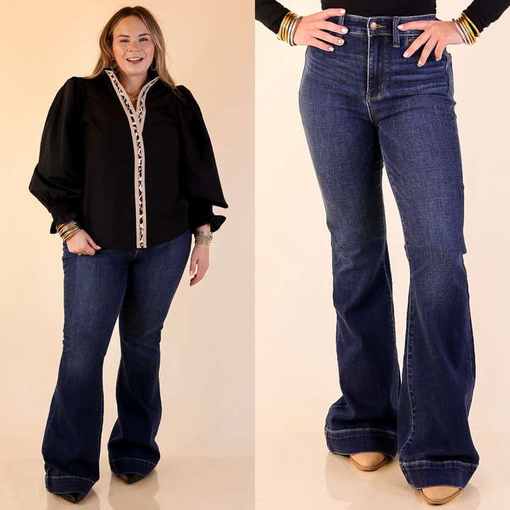 Model is wearing Trouser Flare Jean in Dark Wash with a plain background