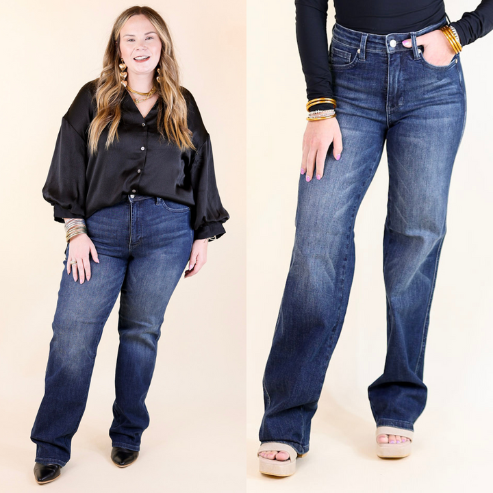 Two people wearing blue jeans and black shirts on a beige background