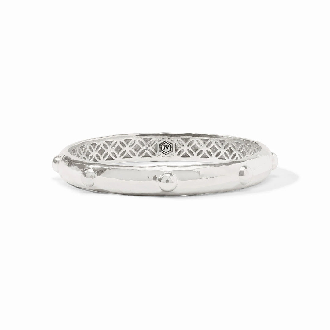 Silver bangle with intricate design on a white background