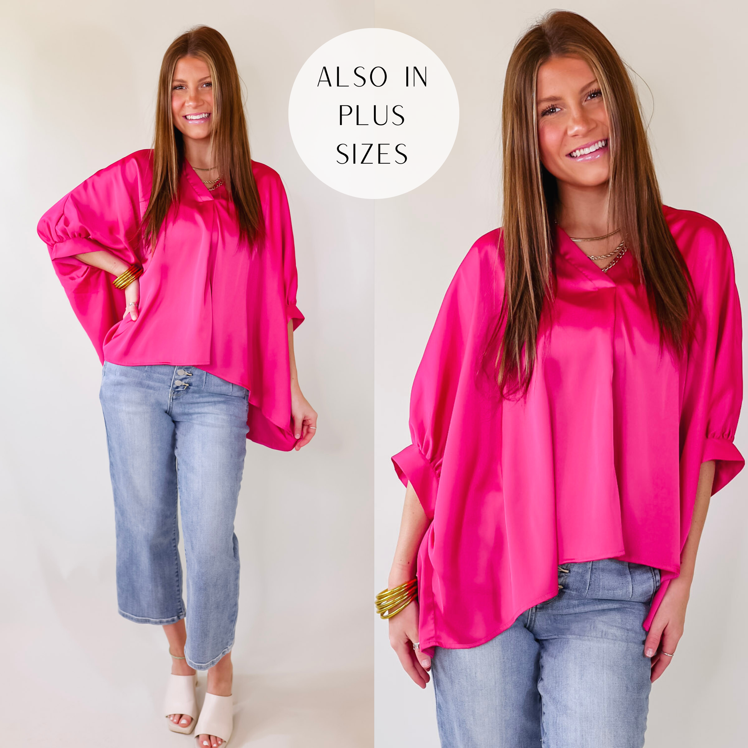 A flowy oversized fuchsia blouse featuring a silky fabric, a V neckline, and cuffed sleeves.