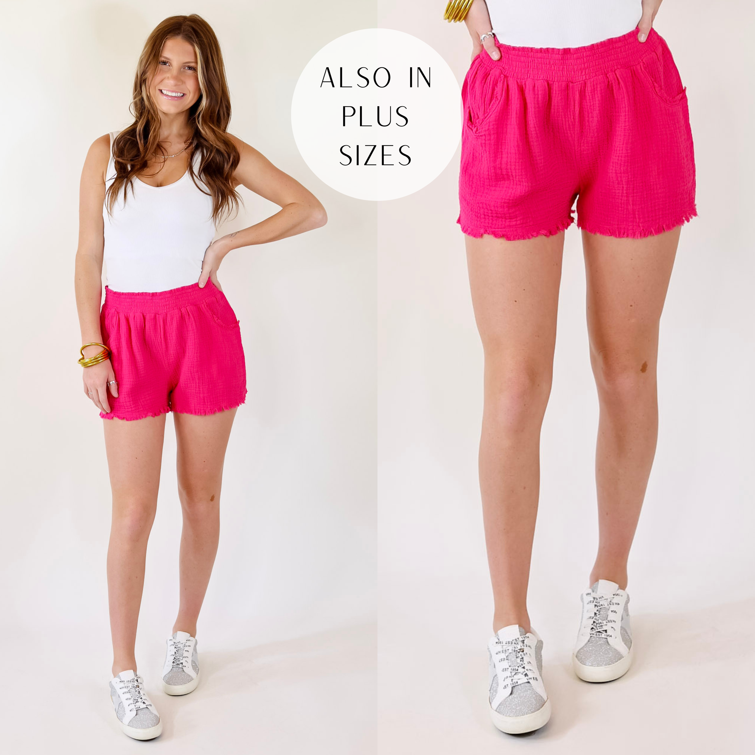 Model is wearing a pair of pink shorts featuring front pockets, stretchy waistband, and distressed hem.
