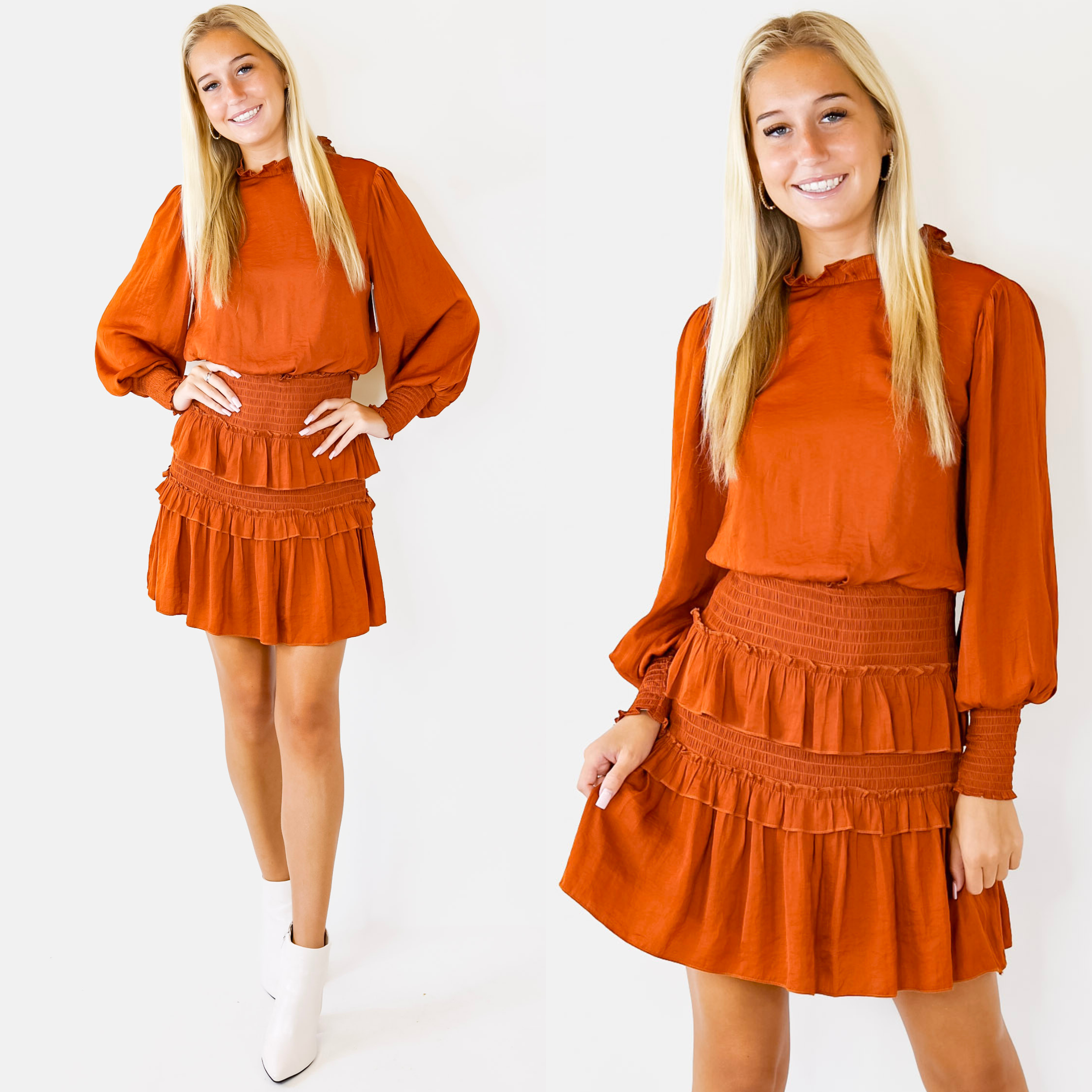 Model is wearing a short orange dress featuring long sleeves with cinched cuffs, ruffled neckline, and a tiered skirt with cinched panels