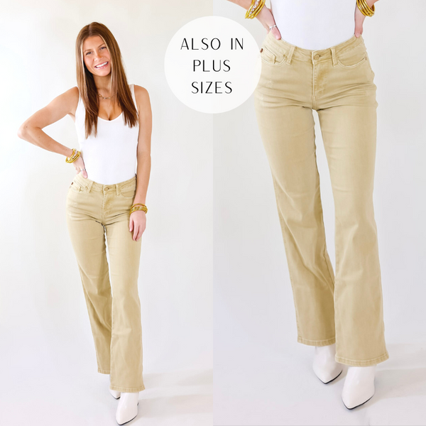 Model is wearing a pair of khaki boot cut jeans. Model has it paired with a white bodysuit, white booties, and gold jewelry.