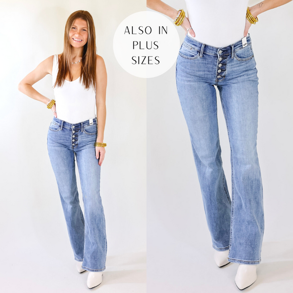Model is wearing a pair of bootcut jeans with a button fly closure. Model has these jeans paired with a white bodysuit, white booties, and gold jewelry.
