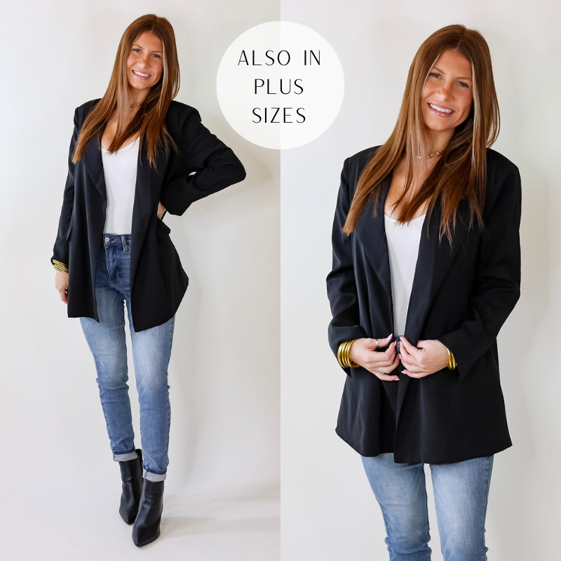 Model is wearing a black blazer with long sleeves and front pockets. Model has paired the blazer ith a white bodysuit, medium wash skinny jeans, black booties, and gold tone jewelry. 