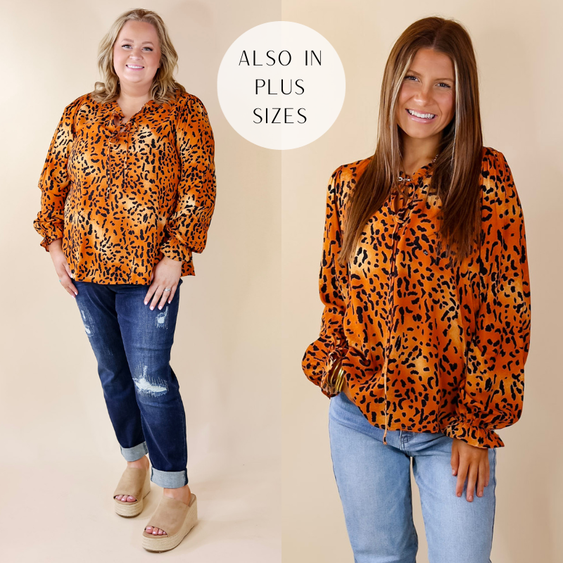 Model is wearing a rust orange long sleeve top with leopard print. Model has paired the top with light wash denim jeans, black booties, and gold tone jewelry.