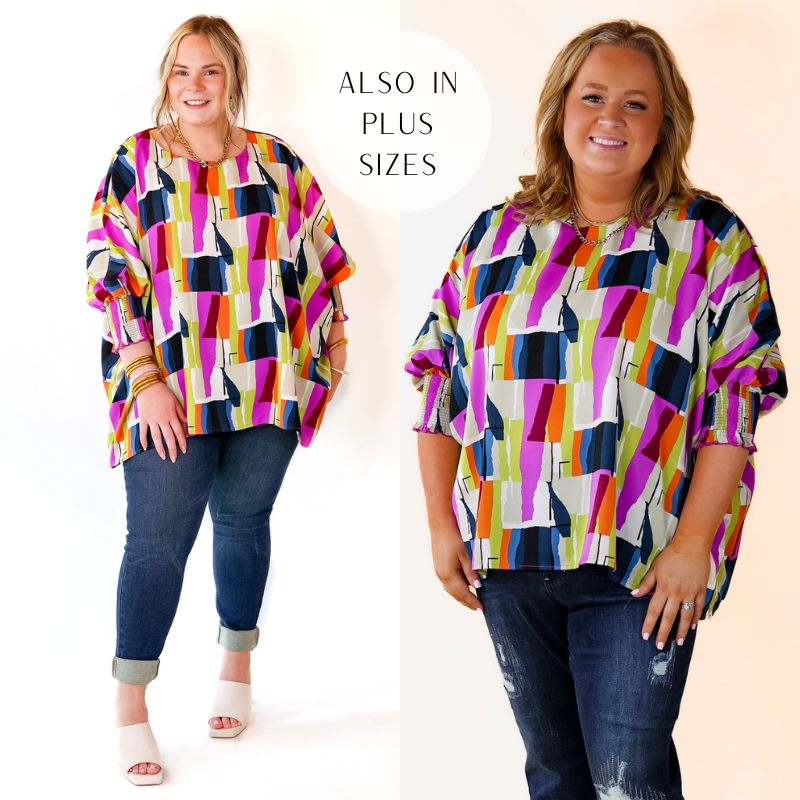 Model is wearing a top with a purple and navy blue abstract pattern. Model has paired the top with dark wash skinny jeans, ivory heels, and gold tone jewelry. 